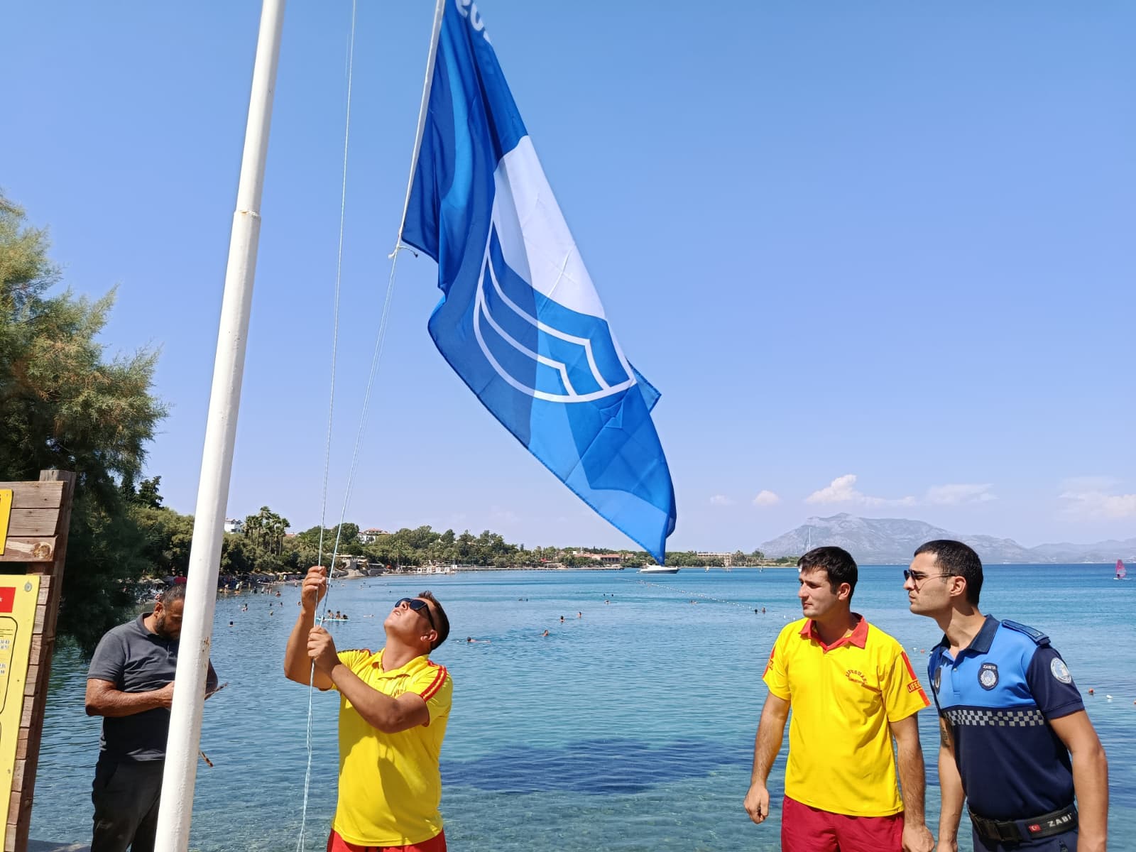 [BELEDIYE · Muğla · Datça] Hastanealtı Plajı’nda Mavi Bayrak yeniden gönderde | Datça Belediyesi
